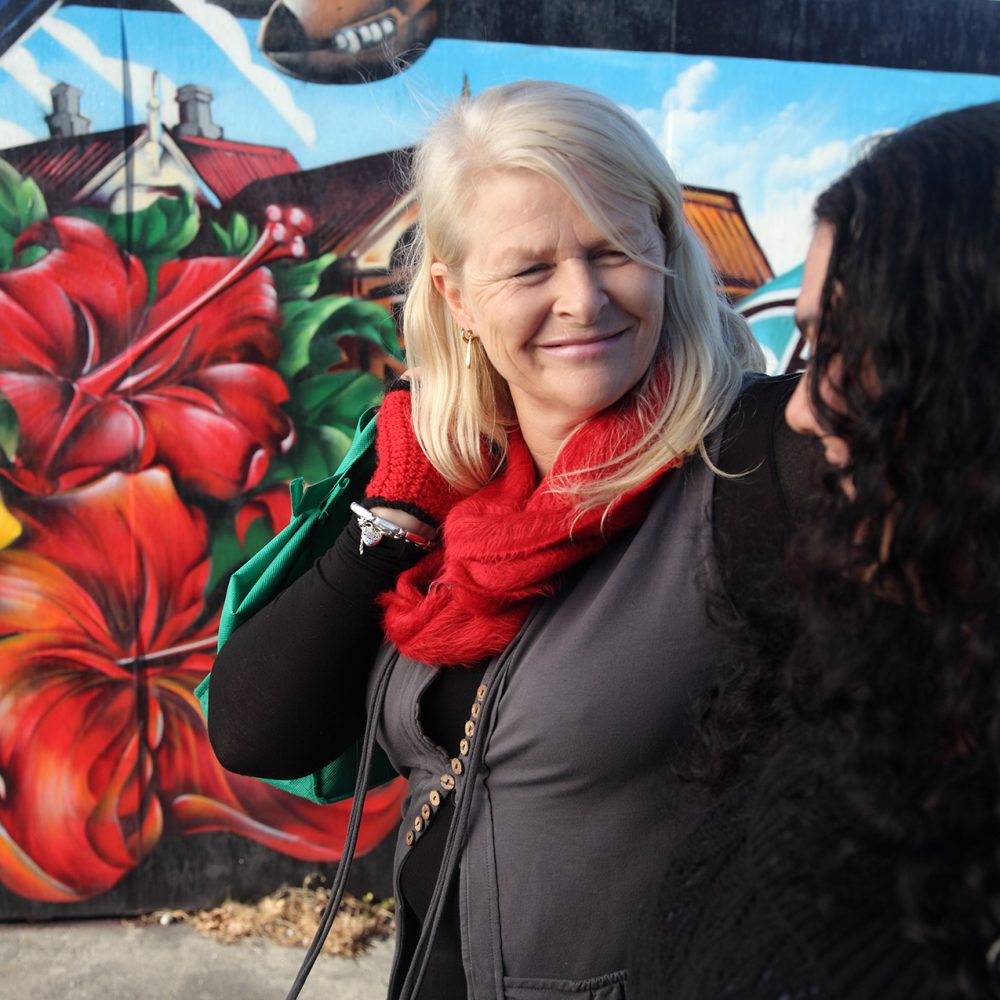 Women-smiling-and-walking-past-street-mural